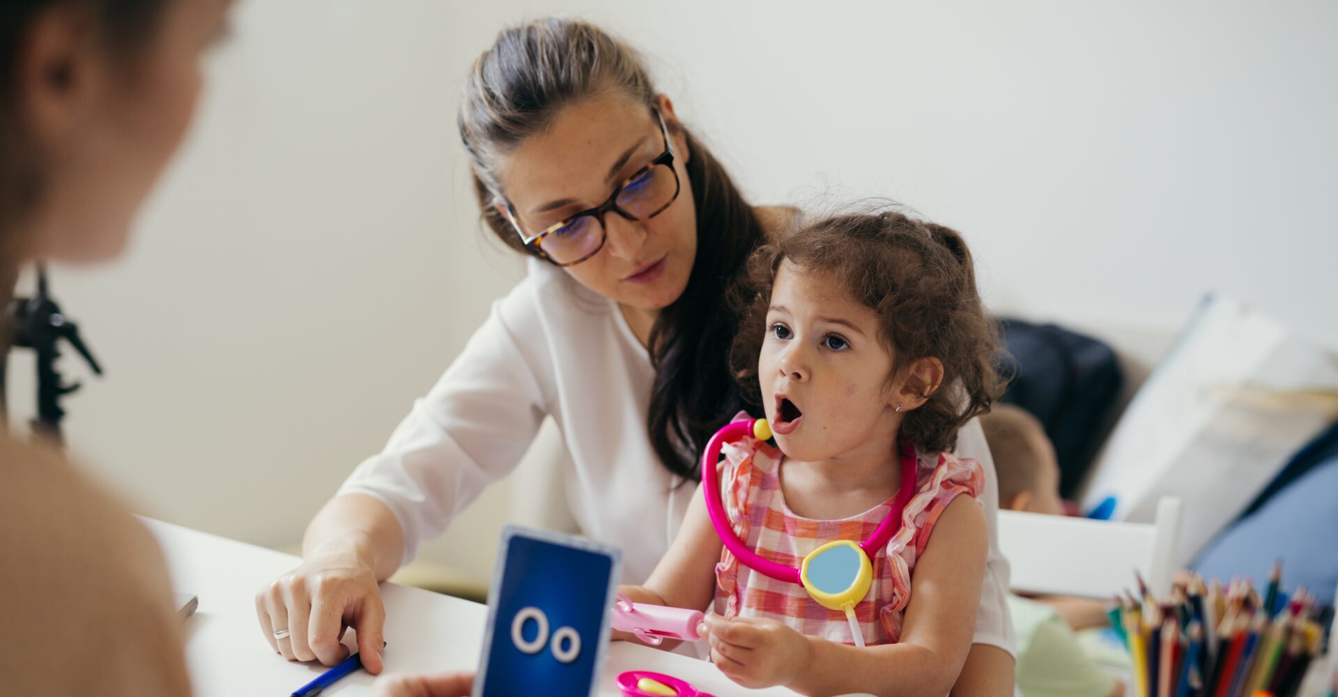 A woman and child are playing with toys.